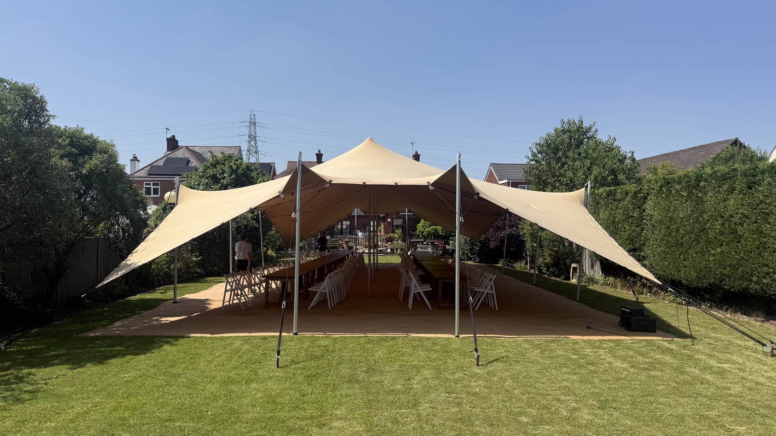 Tan stretch tent over event seating